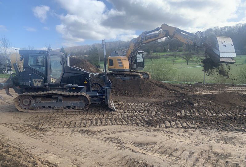 Der Boden wird mit schweren Baumaschinen bearbeitet